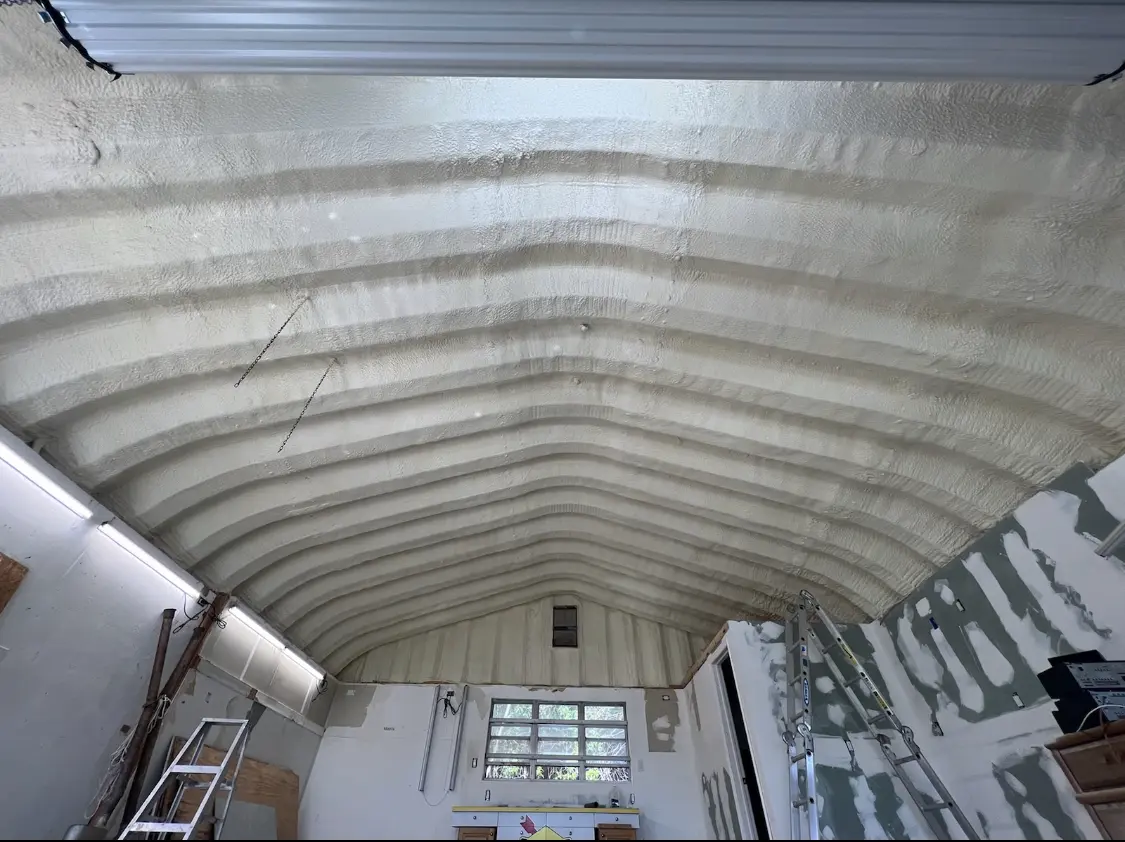 Spray polyurethane foam applied to the underside of a metal roof deck in Rensselaer